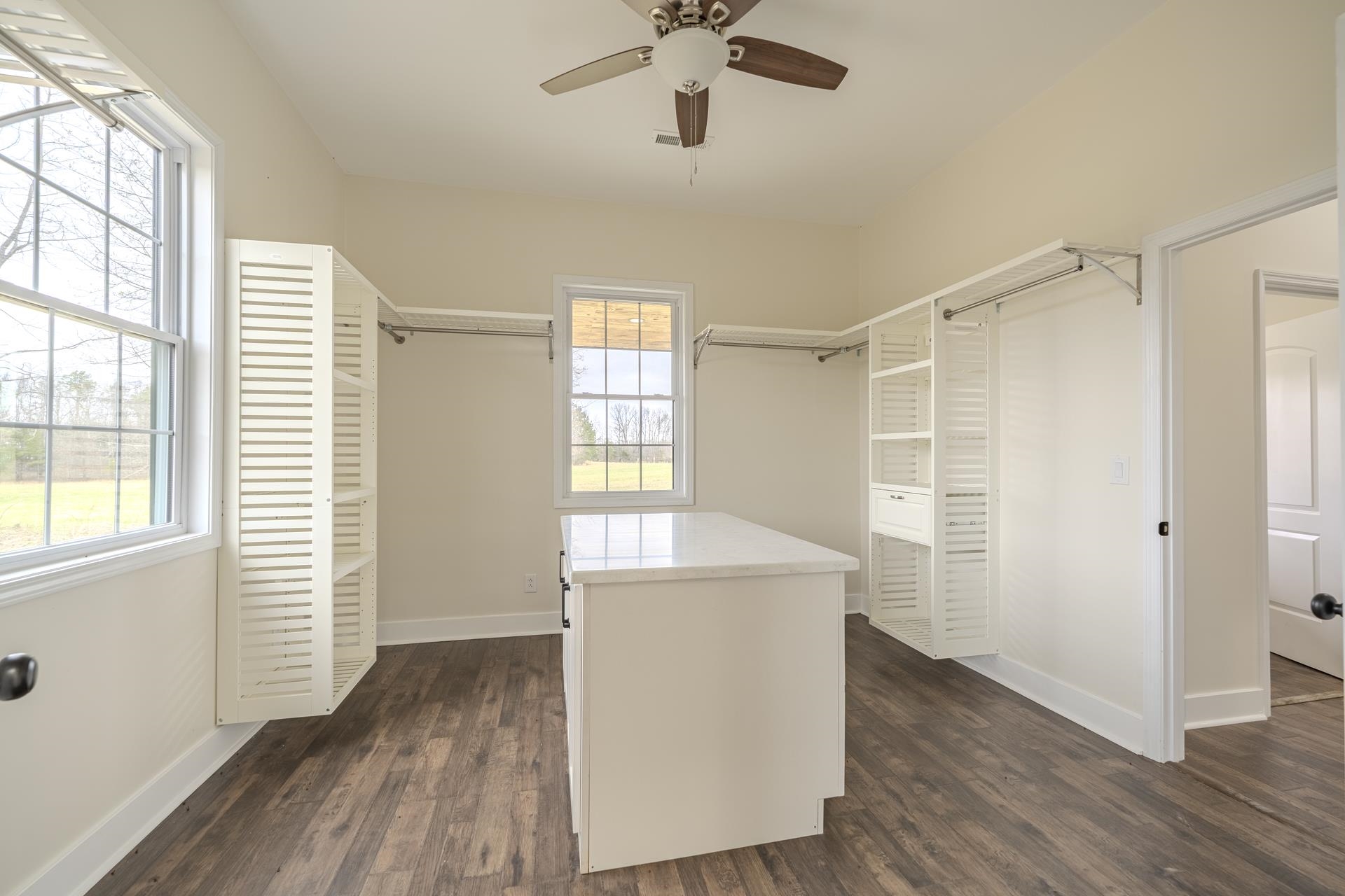 1030 Robbins Road Collinwood, TN 38450 - Photo 22 of 40 Walk in closet with dark wood finished floors and a ceiling fan