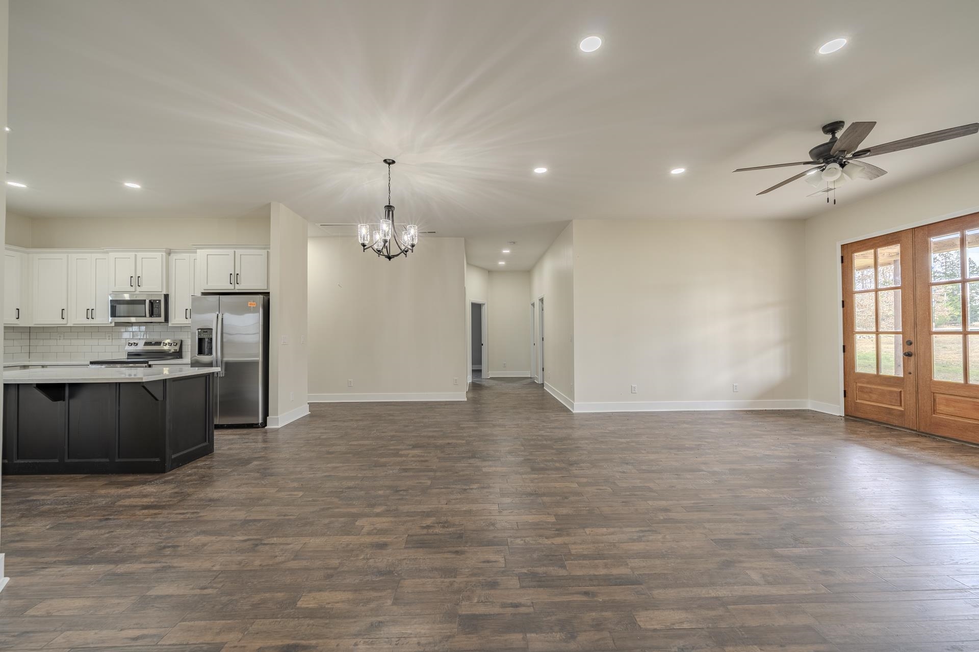 1030 Robbins Road Collinwood, TN 38450 - Photo 40 of 40 Kitchen with open floor plan, stainless steel appliances, a ceiling fan, dark wood-style floors, and french doors