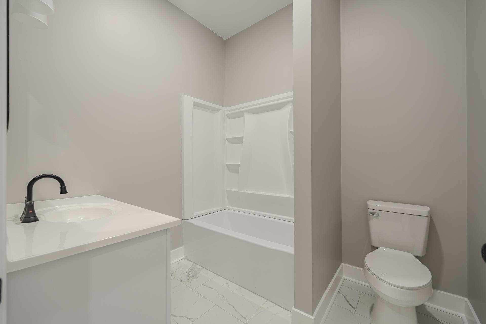 1030 Robbins Road Collinwood, TN 38450 - Photo 23 of 40 Bathroom with light marble finish floors, vanity, and shower / bathtub combination