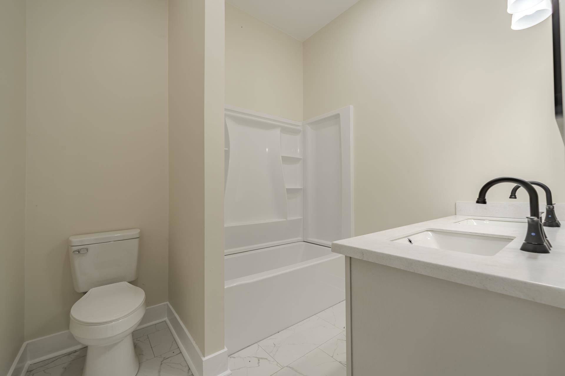 1030 Robbins Road Collinwood, TN 38450 - Photo 25 of 40 Full bathroom featuring double vanity, light marble finish flooring, and shower / bathtub combination