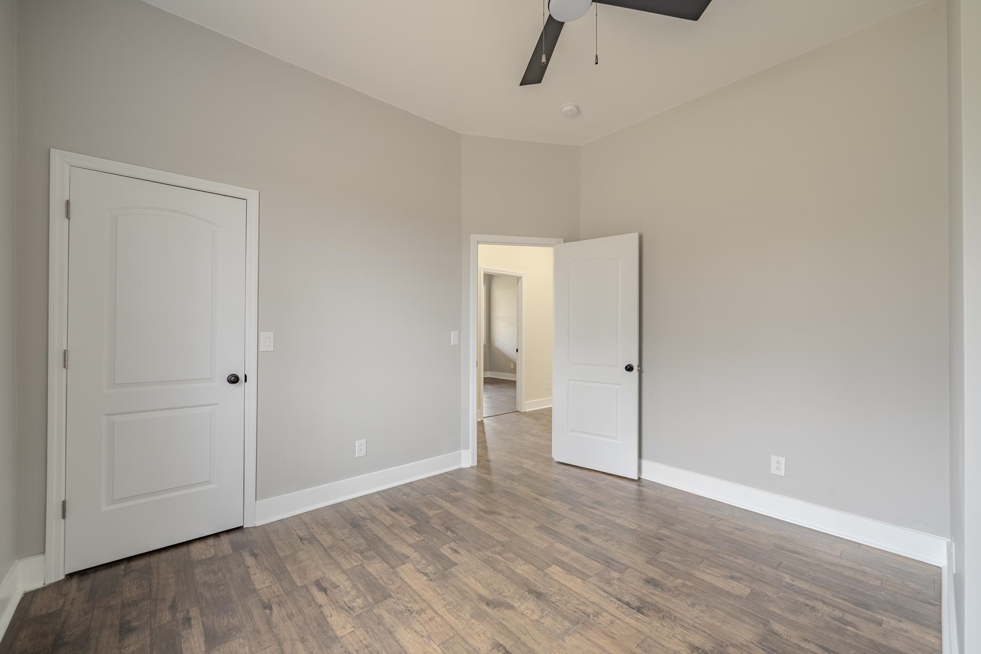 1030 Robbins Road Collinwood, TN 38450 - Photo 26 of 40 Unfurnished bedroom featuring dark wood-style flooring and a ceiling fan