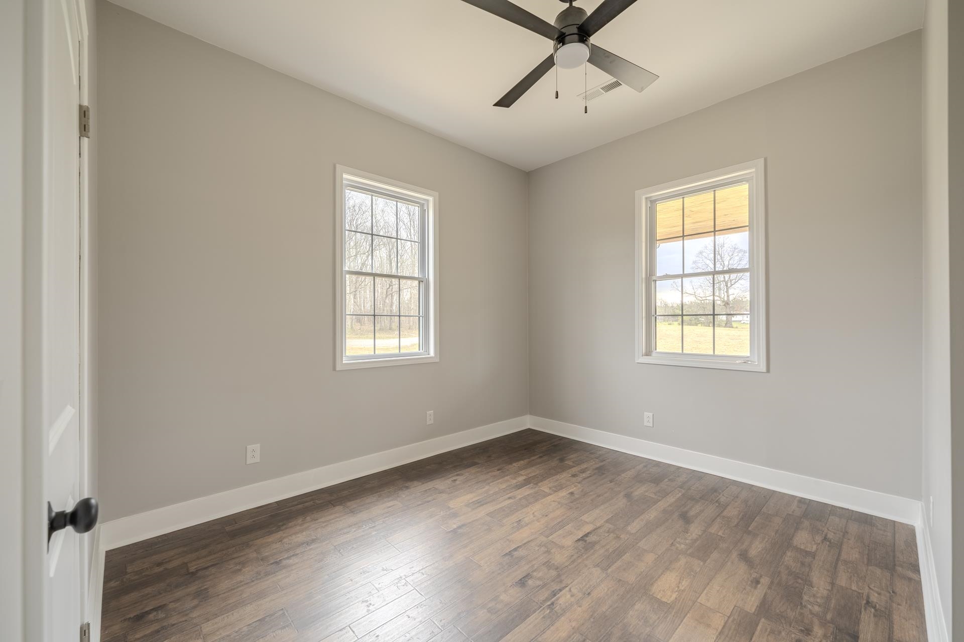 1030 Robbins Road Collinwood, TN 38450 - Photo 27 of 40 Unfurnished room with dark wood-type flooring, plenty of natural light, and a ceiling fan