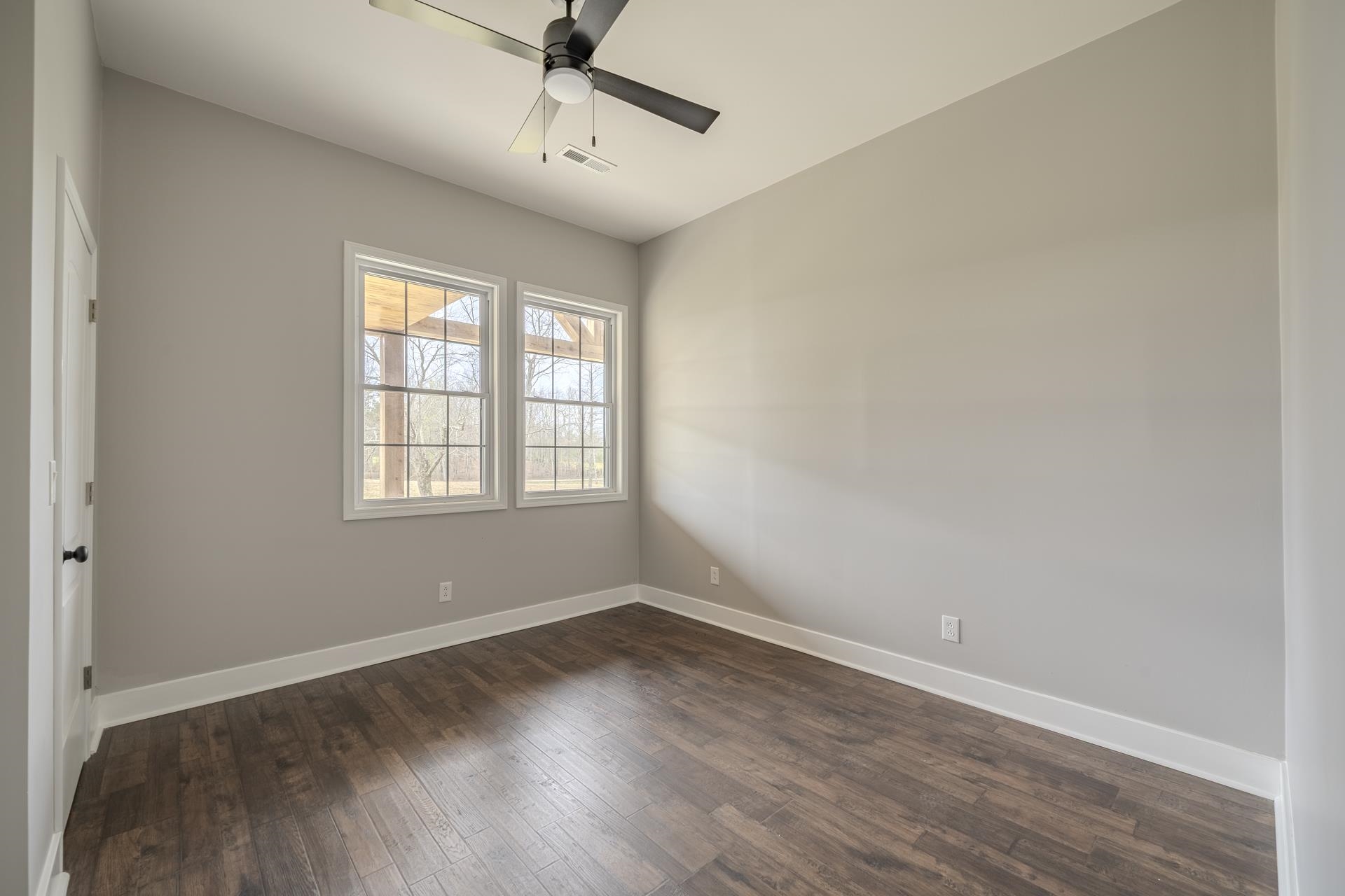 1030 Robbins Road Collinwood, TN 38450 - Photo 28 of 40 Empty room with dark wood-style flooring and a ceiling fan