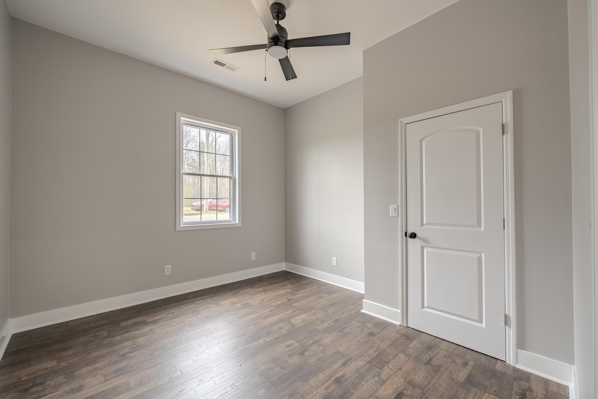1030 Robbins Road Collinwood, TN 38450 - Photo 29 of 40 Empty room featuring ceiling fan and dark wood finished floors