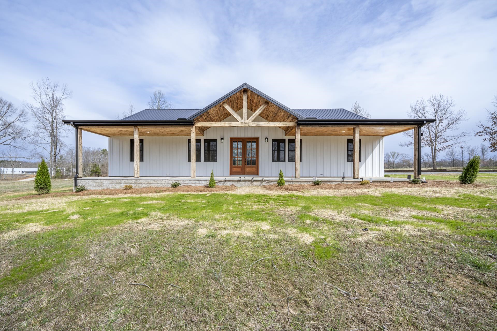 1030 Robbins Road Collinwood, TN 38450 - Photo 36 of 40 View of front of house featuring a porch, french doors, a metal roof, and a front yard
