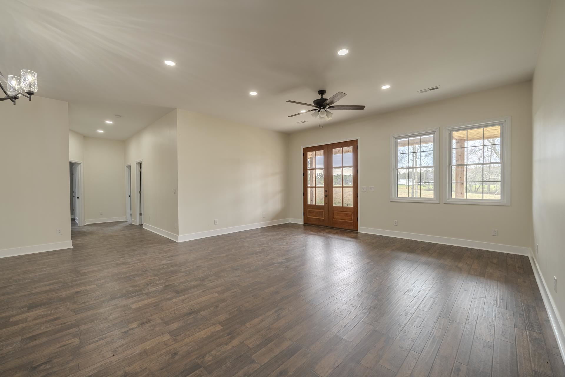 1030 Robbins Road Collinwood, TN 38450 - Photo 9 of 40 Empty room featuring recessed lighting, dark wood-type flooring, a ceiling fan, and french doors