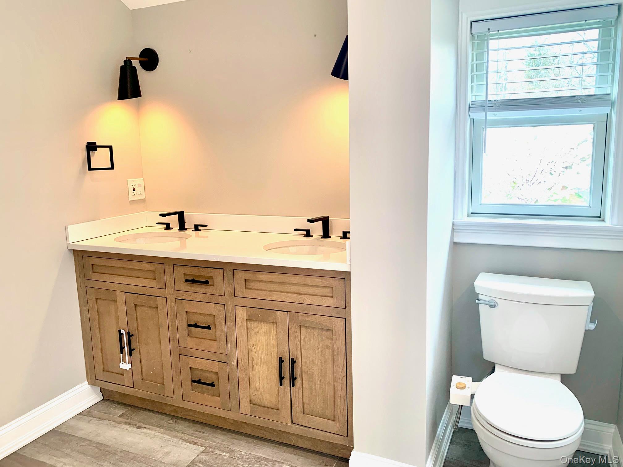 435 Middle Road Riverhead, NY 11901 - Photo 13 of 19 a bathroom with a sink mirror vanity and toilet