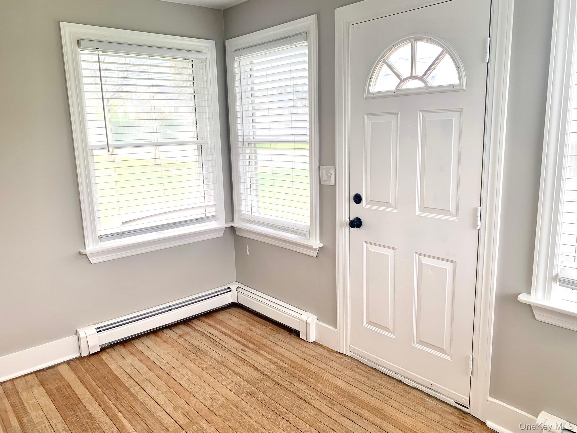 435 Middle Road Riverhead, NY 11901 - Photo 16 of 19 a view of an empty room with wooden floor and a window