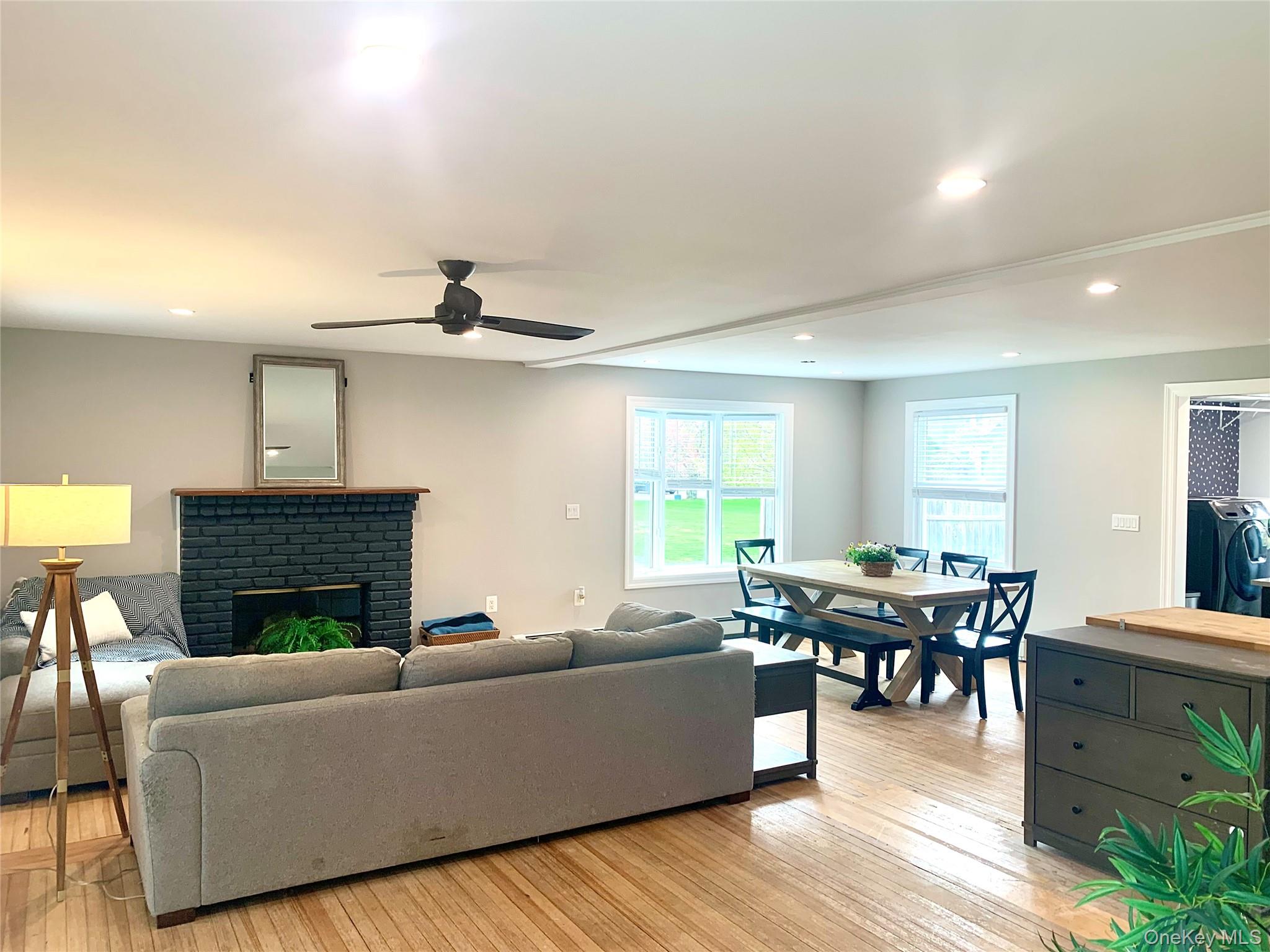 435 Middle Road Riverhead, NY 11901 - Photo 7 of 19 a living room with furniture a fireplace and a table