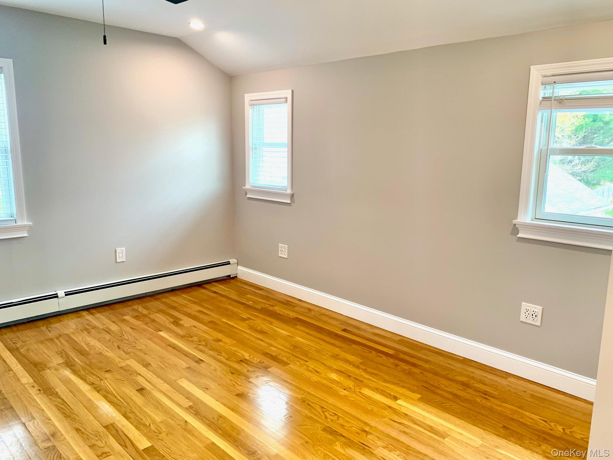435 Middle Road Riverhead, NY 11901 - Photo 10 of 19 a view of an empty room with wooden floor and a window