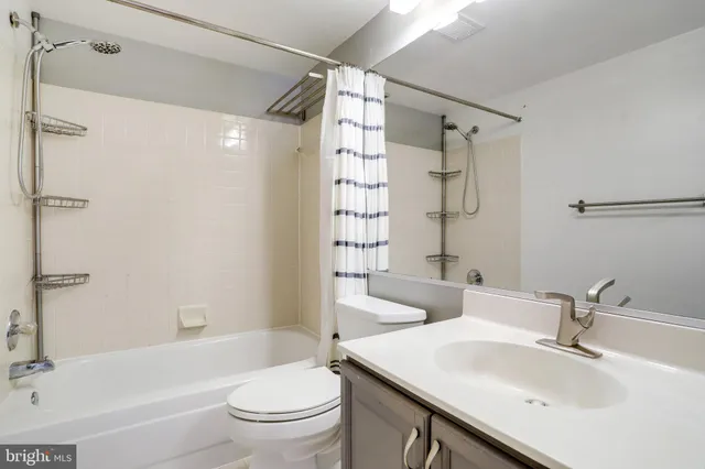 a bathroom with a sink toilet tub and shower