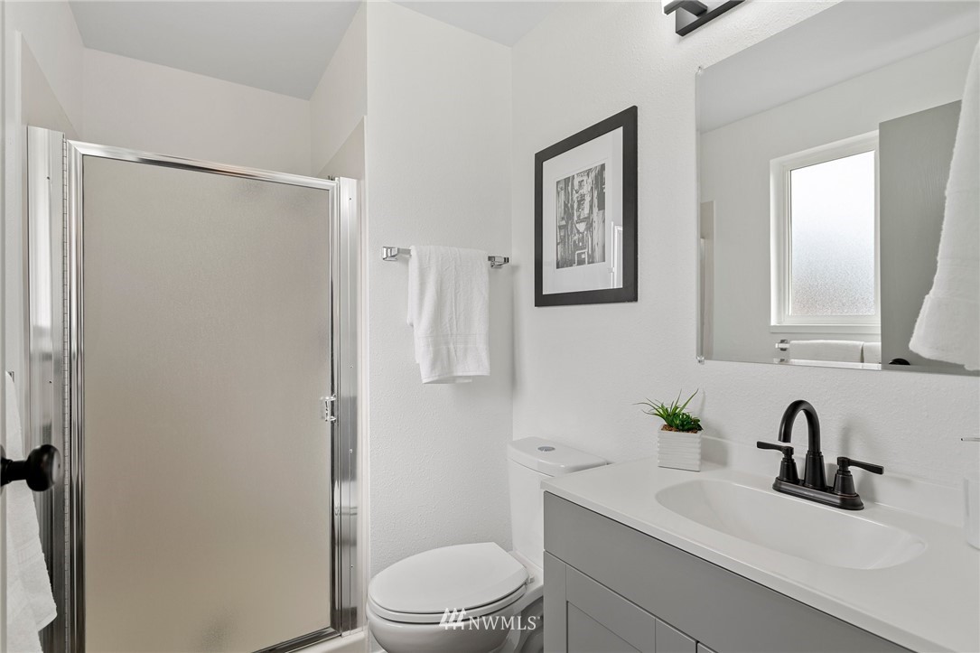 2624 166th Street Southeast Bothell, WA 98012 - Photo 14 of 29 a bathroom with a toilet a sink and mirror