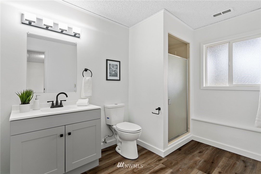 2624 166th Street Southeast Bothell, WA 98012 - Photo 24 of 29 a bathroom with a sink a toilet and a mirror