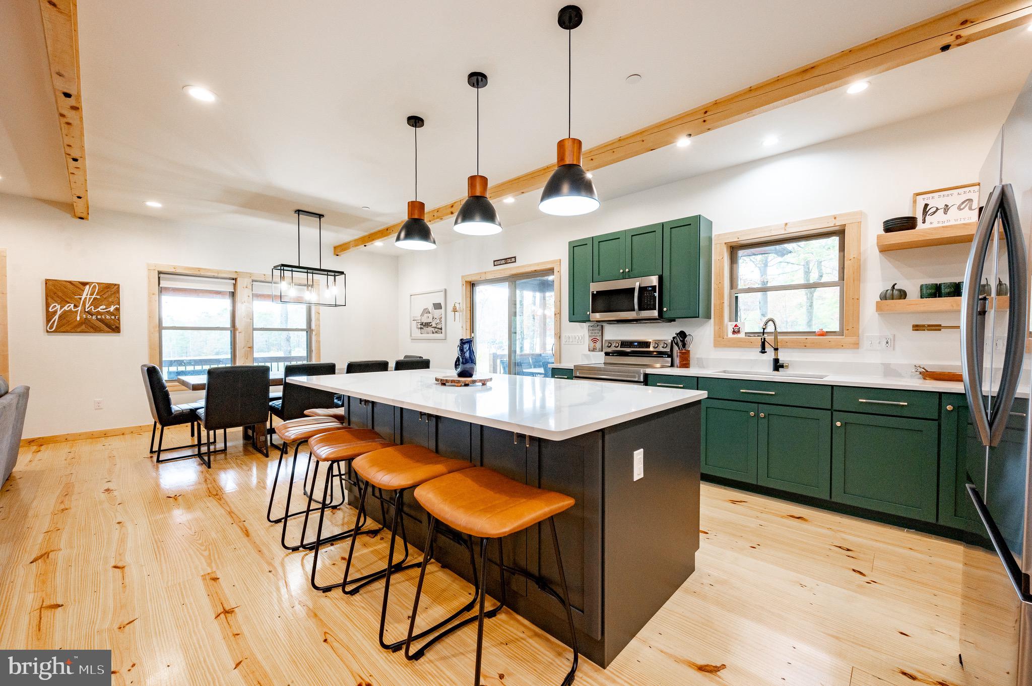 36 Irwin Way Oakland, MD 21550 - Photo 13 of 64 a kitchen with stainless steel appliances granite countertop a sink a stove and a wooden floors