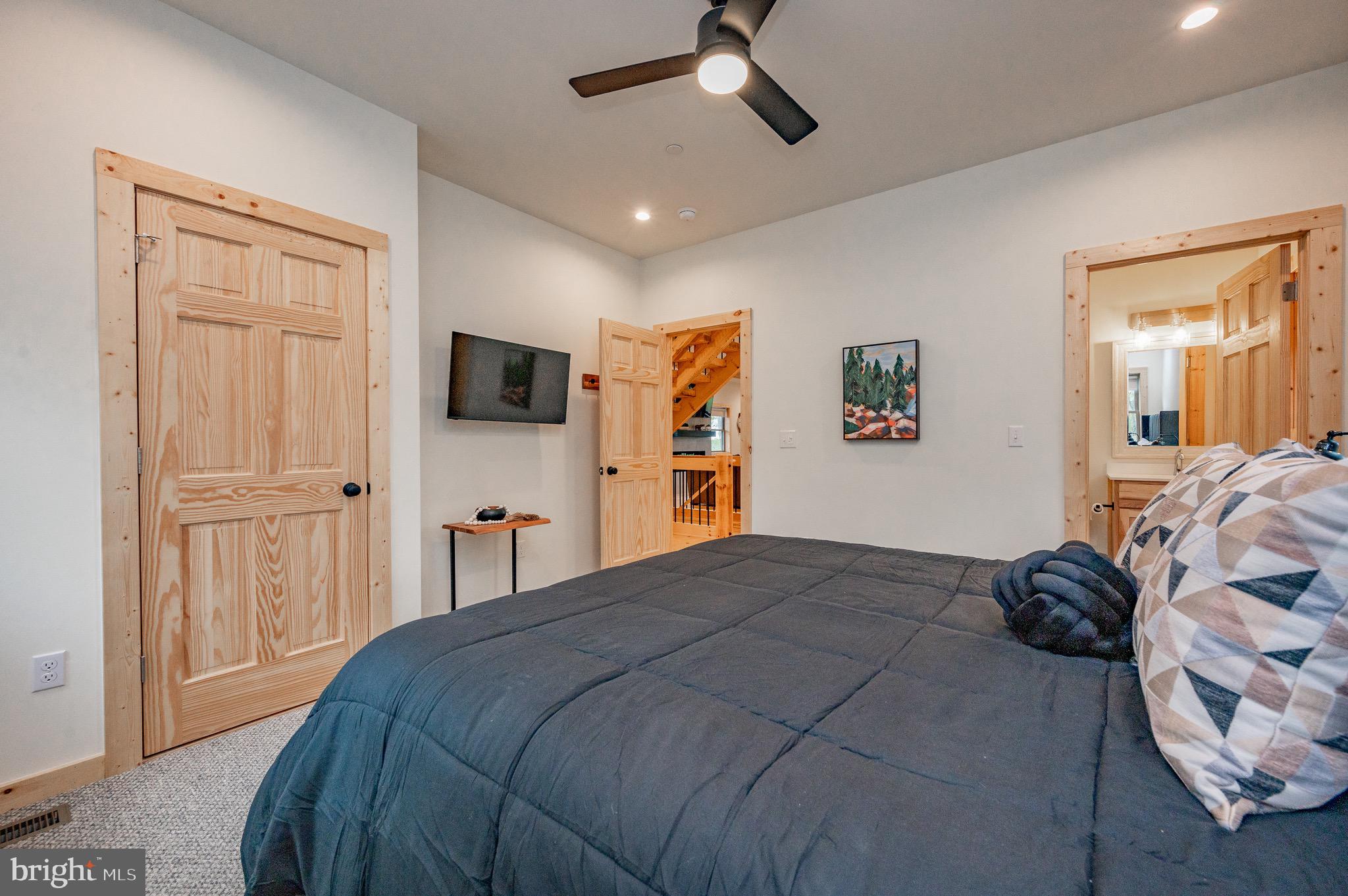 36 Irwin Way Oakland, MD 21550 - Photo 39 of 64 a bedroom with a bed and a flat tv screen