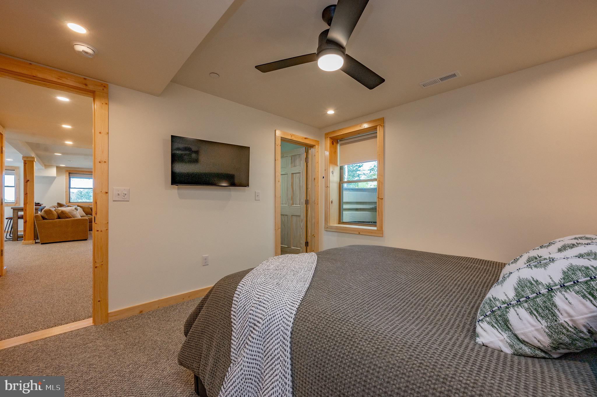 36 Irwin Way Oakland, MD 21550 - Photo 58 of 64 a bedroom with a bed and a flat screen tv