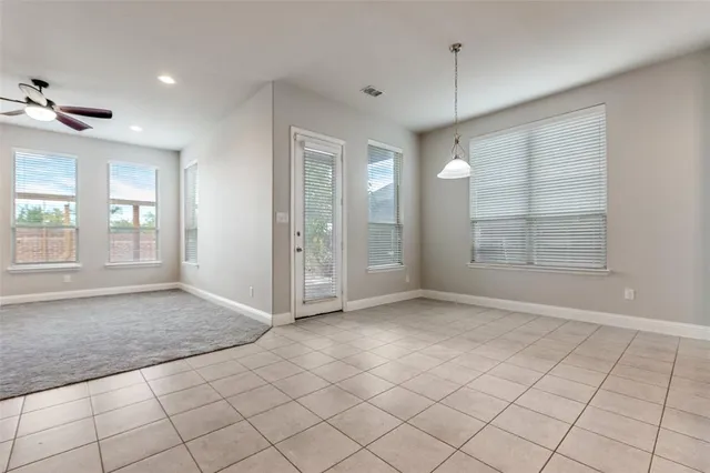 an empty room with windows and painted walls