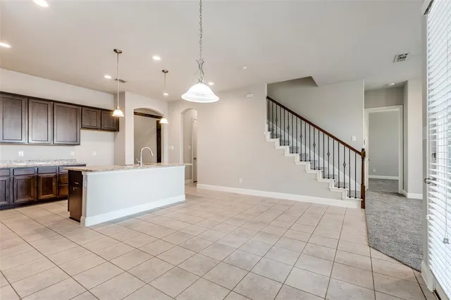 a kitchen with a sink a counter space and a refrigerator