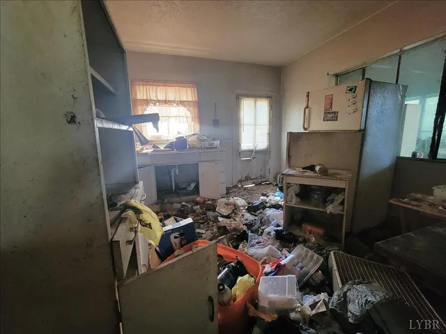 a room with furniture a flat screen tv and a window