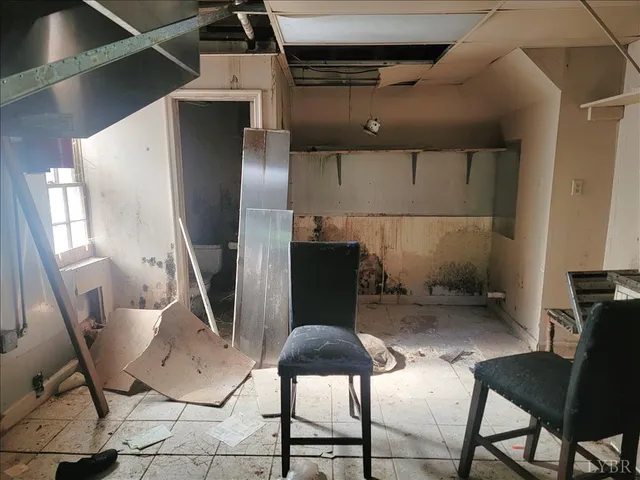 a table chair sitting in a room next to a window