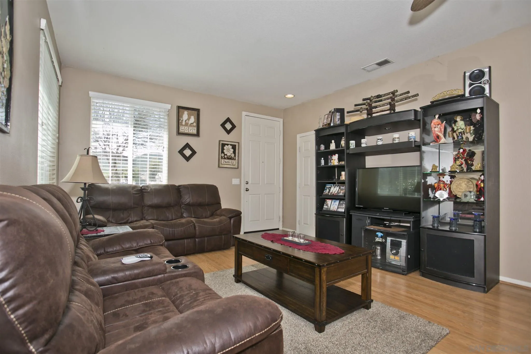 4660 Duskywing Road Hemet, CA 92545 - Photo 12 of 29 a living room with furniture a flat screen tv and a window