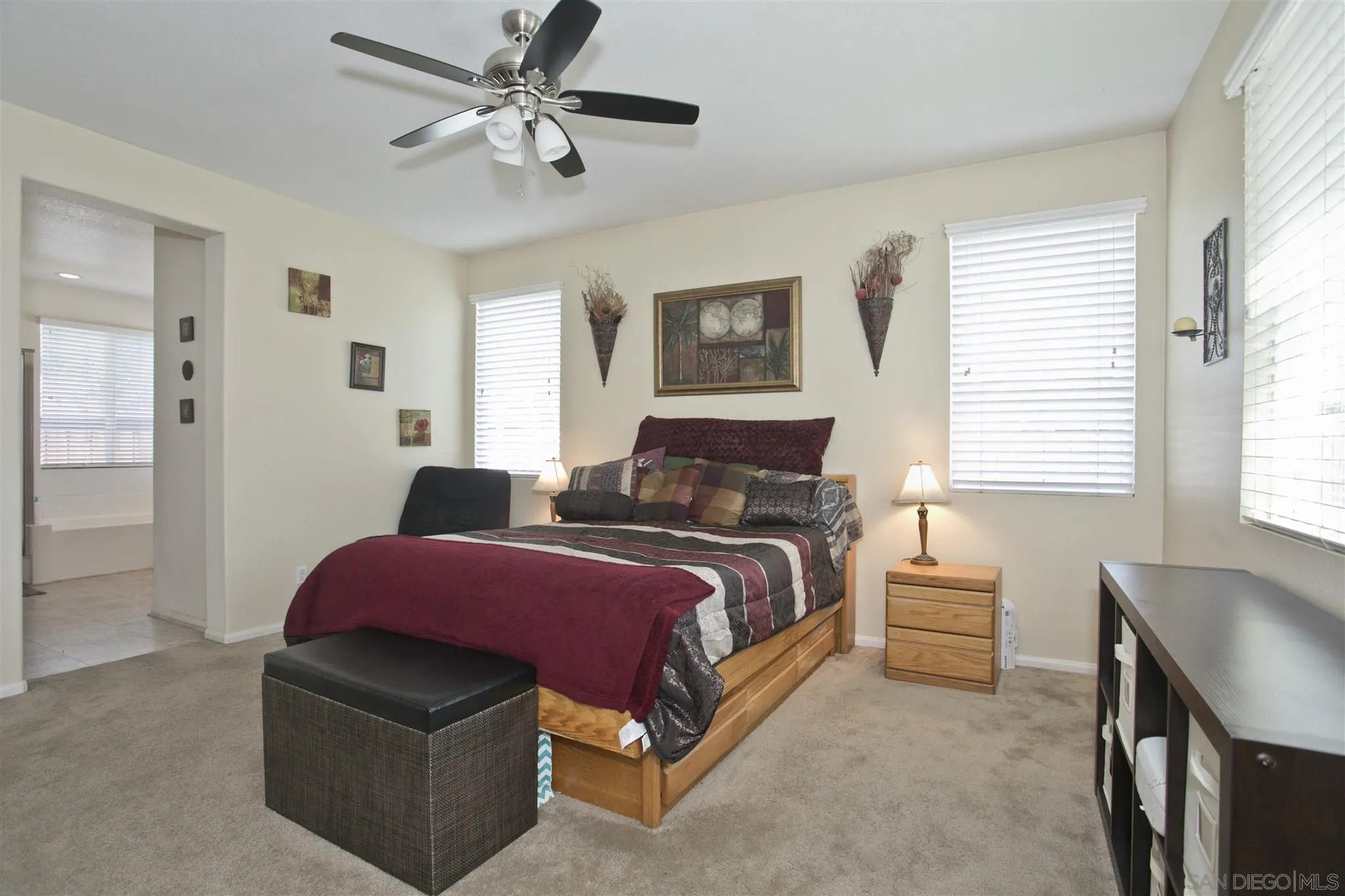 4660 Duskywing Road Hemet, CA 92545 - Photo 15 of 29 a spacious bedroom with a bed and a chandelier