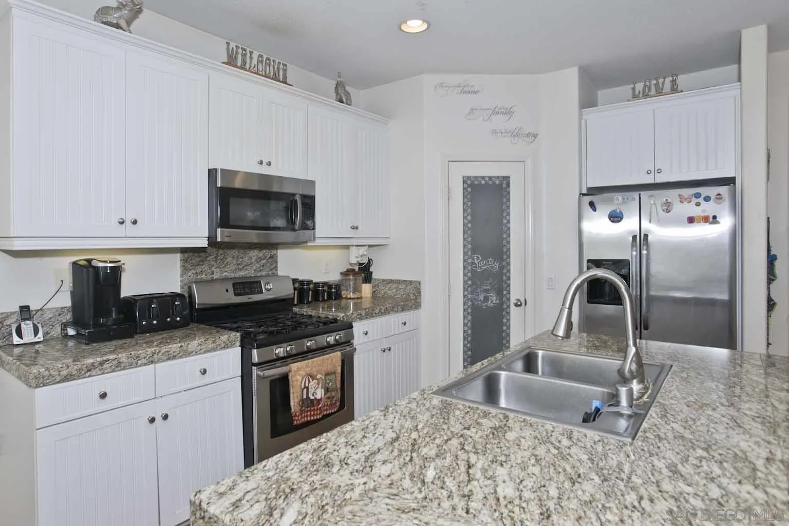 4660 Duskywing Road Hemet, CA 92545 - Photo 3 of 29 a kitchen with stainless steel appliances granite countertop a refrigerator a stove top oven a sink and dishwasher
