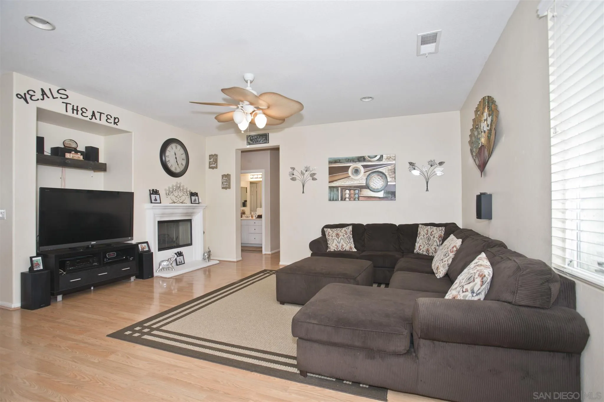 4660 Duskywing Road Hemet, CA 92545 - Photo 9 of 29 a living room with furniture a flat screen tv and a fireplace