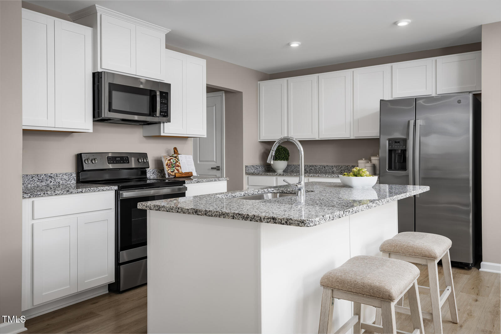 152 Cavalier Rider Run Wendell, NC 27591 - Photo 2 of 21 a kitchen with stainless steel appliances granite countertop a sink a stove a microwave a refrigerator and cabinets