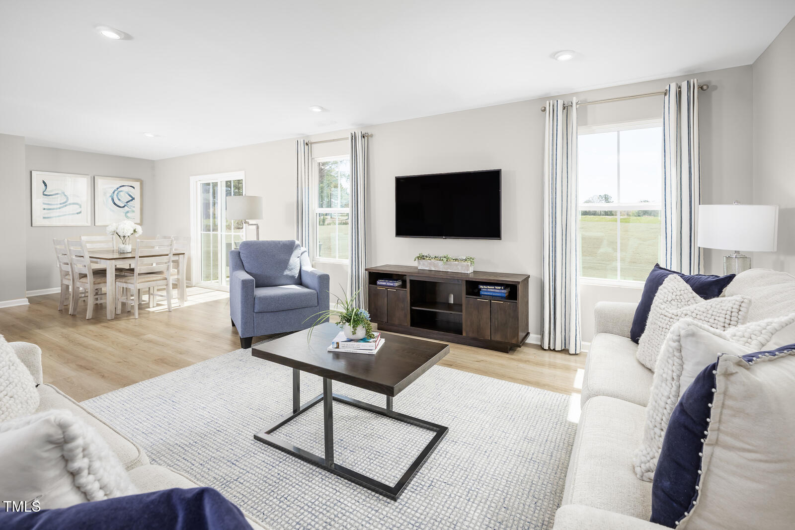 152 Cavalier Rider Run Wendell, NC 27591 - Photo 8 of 21 a living room with furniture a flat screen tv and a large window