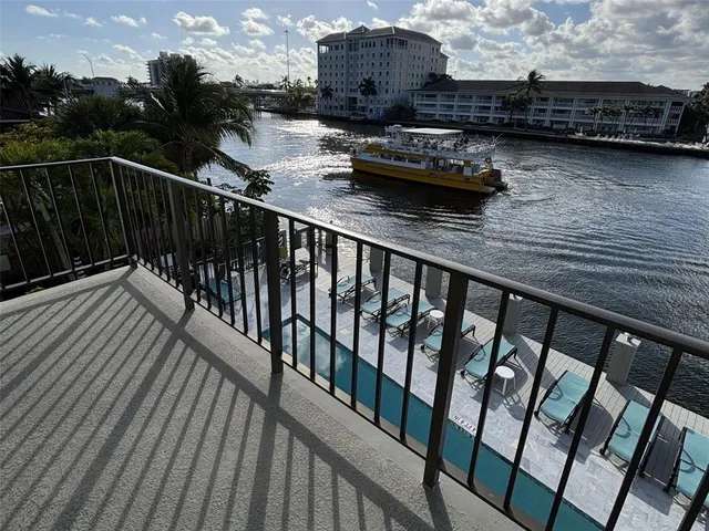 a view of a balcony with chairs and wooden floor