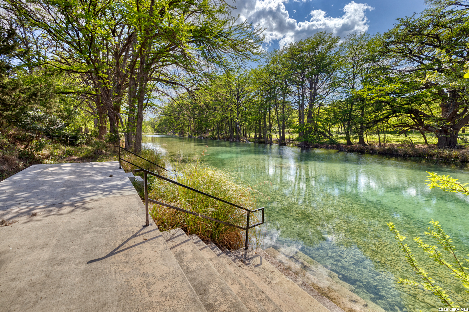 869 Ridge Loop Rio Frio, TX 78879 - Photo 15 of 40 a view of a lake with a house in the background