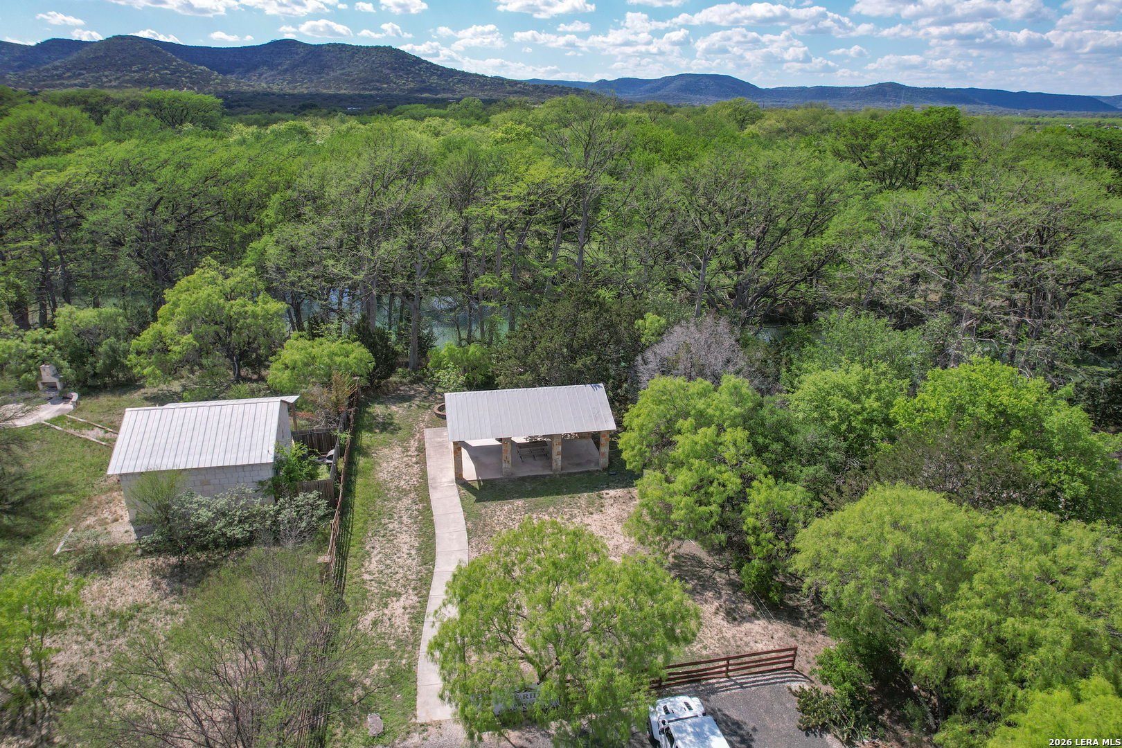 869 Ridge Loop Rio Frio, TX 78879 - Photo 39 of 40 an aerial view of a house with a yard and a large tree