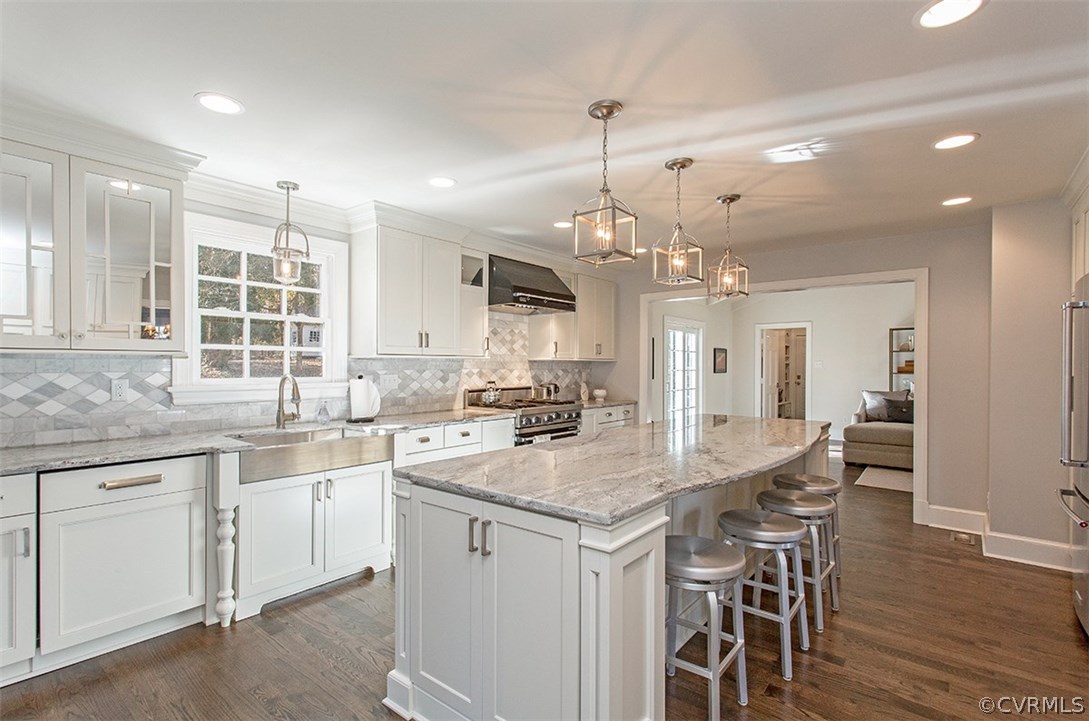 9733 Cherokee Road Richmond, VA 23235 - Photo 10 of 26 a kitchen with center island table and chairs in it