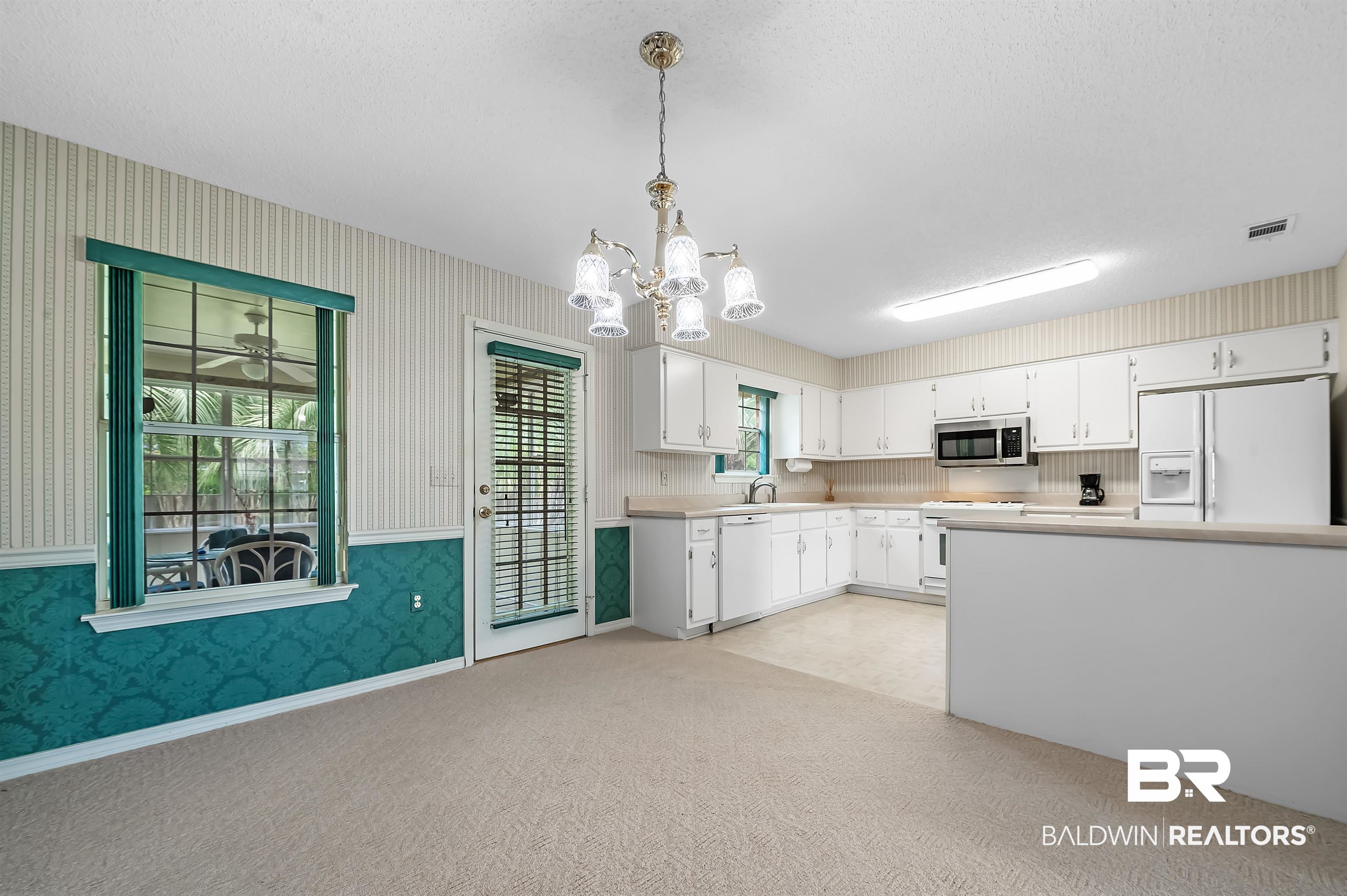 1502 Mulberry Lane Foley, AL 36535 - Photo 15 of 45 Kitchen featuring white cabinets, white appliances, and light colored carpet