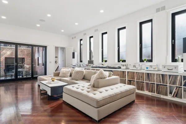 a living room with furniture and large windows
