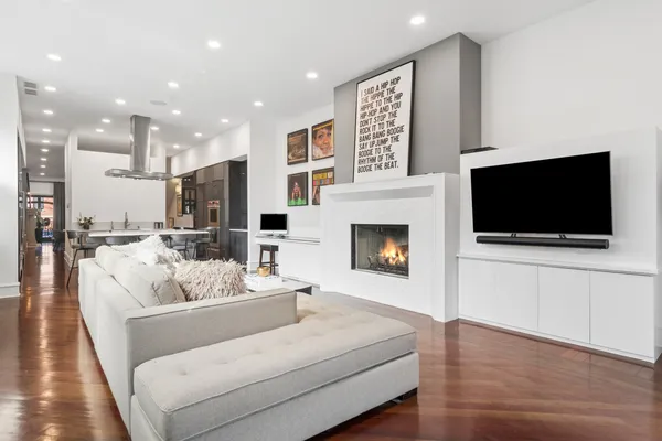 a living room with furniture a flat screen tv and a fireplace