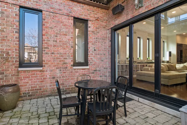 a view of a patio with table and chairs