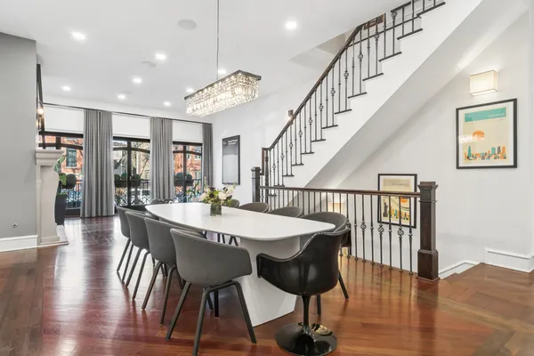 a view of a a dining room with furniture window and wooden floor