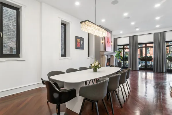 a view of a a dining room with furniture window and wooden floor
