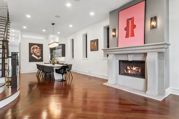 a living room with furniture a fireplace and kitchen view
