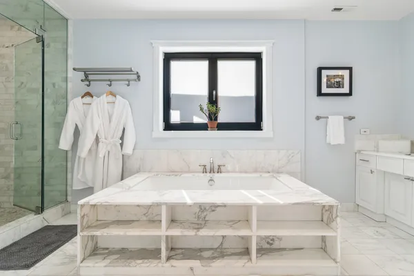 a spacious bathroom with a sink a mirror and a bathtub