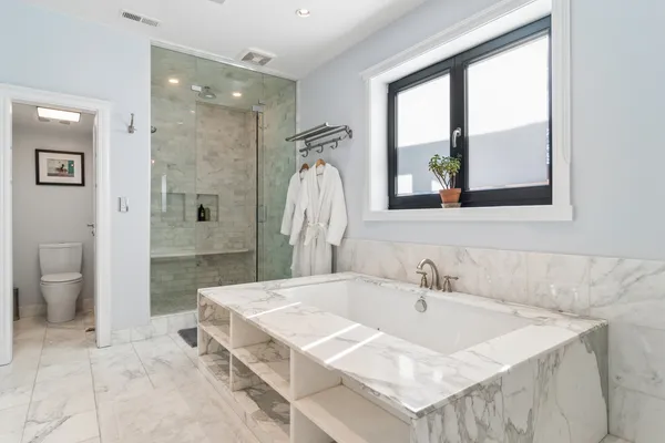 a bathroom with double sink and a mirror