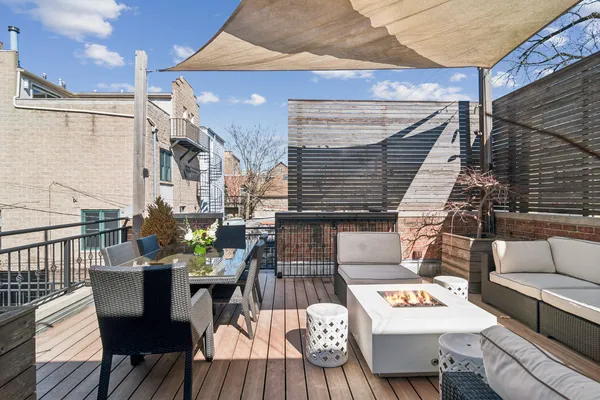 a view of a patio with a table and chairs and floor to ceiling window