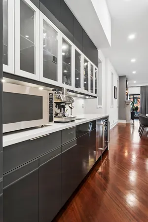 a kitchen with stainless steel appliances granite countertop a cabinets and wooden floor