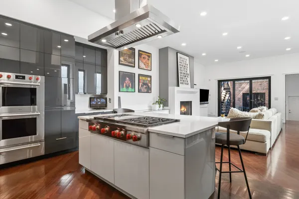 a open kitchen with stainless steel appliances granite countertop a stove and a refrigerator