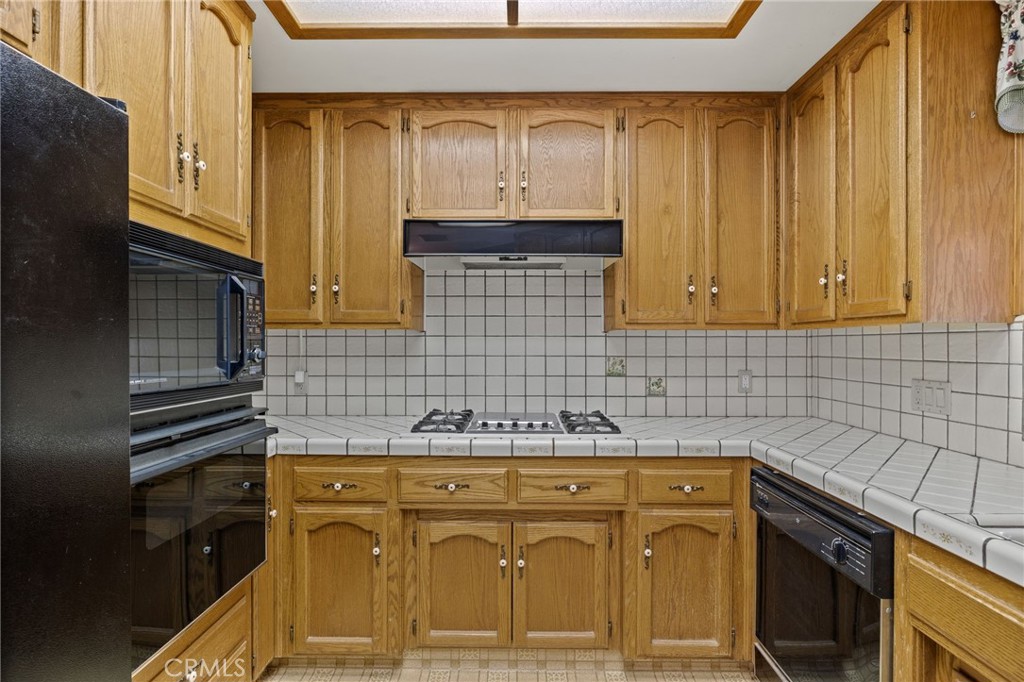 2065 Jenkins Road Bakersfield, CA 93314 - Photo 15 of 59 a kitchen with stainless steel appliances granite countertop a sink stove and cabinets