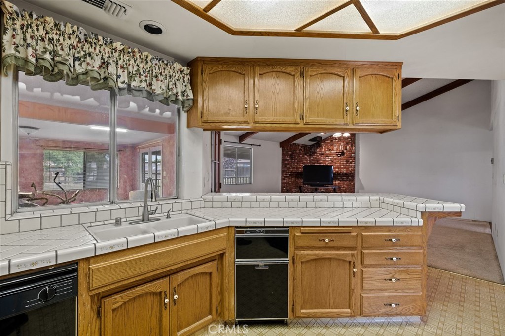 2065 Jenkins Road Bakersfield, CA 93314 - Photo 17 of 59 a kitchen with stainless steel appliances granite countertop a sink and cabinets