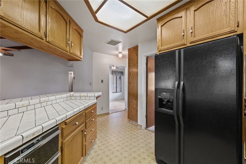 2065 Jenkins Road Bakersfield, CA 93314 - Photo 19 of 59 a kitchen with stainless steel appliances granite countertop a refrigerator and a stove