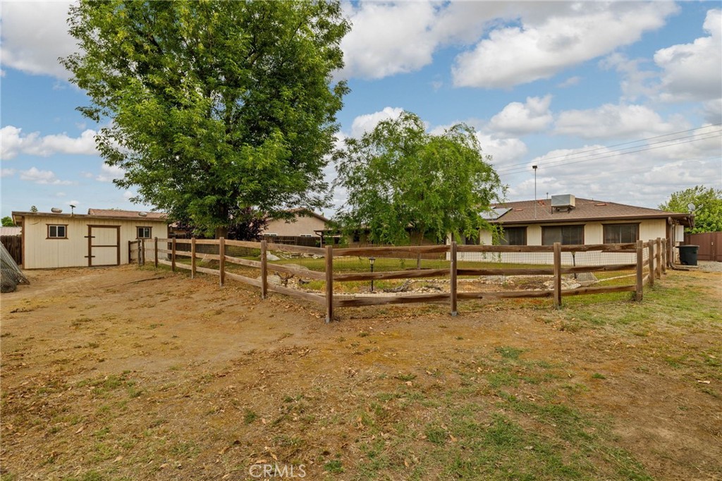 2065 Jenkins Road Bakersfield, CA 93314 - Photo 5 of 59 a view of backyard with wooden fence and a bench